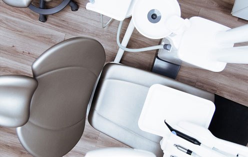 A dental office with a dental chair, tools, and equipment