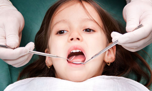 A young child at the dentist receiving pediatric dental care