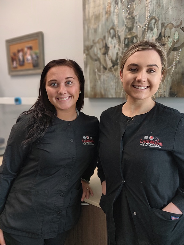A photo of two dental assistants at LandMark Dentistry