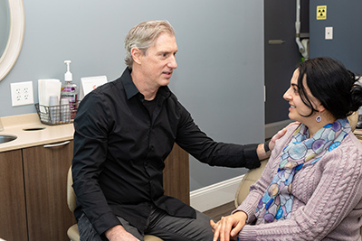 Dr. Mark Tripp meeting with a patient in a dental office